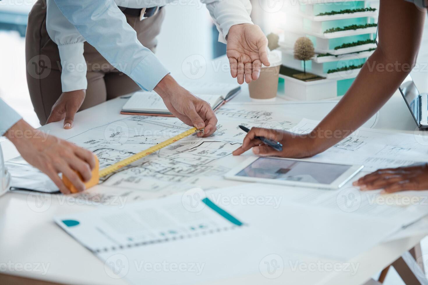 Professionals reviewing architectural plans and relocation strategy
